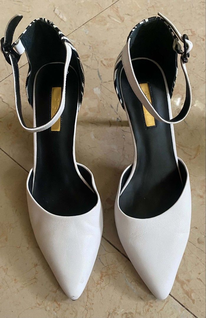 White Pointed Toe Heels with Ankle Strap and Zebra Print Heel (Category: Heels) located in Cebu City. Submitted by arni1 (Listing ID 1452157606, Image 1). Description: - White pointed toe heels - Secure ankle strap - Unique zebra print heel detail - Minor scuffs on toe area - Size: 240 (EU 37.5).