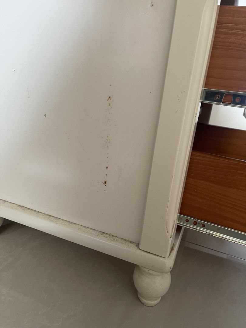 White Solid Wood Two-Drawer Nightstand with Round Knobs (Category: Shelves, Cabinets & Racks) located in Singapore. Submitted by reityz. (Listing ID 1452200194, Image 3). Description: 41.5cm/49.5cm/51.5cm - White solid wood bedside table - Two drawers with easy-open round wooden knobs - Slightly rounded top edge - Classic turned legs - Warm wood tone drawer interiors - Minor marks and dust visible on surface and sides .