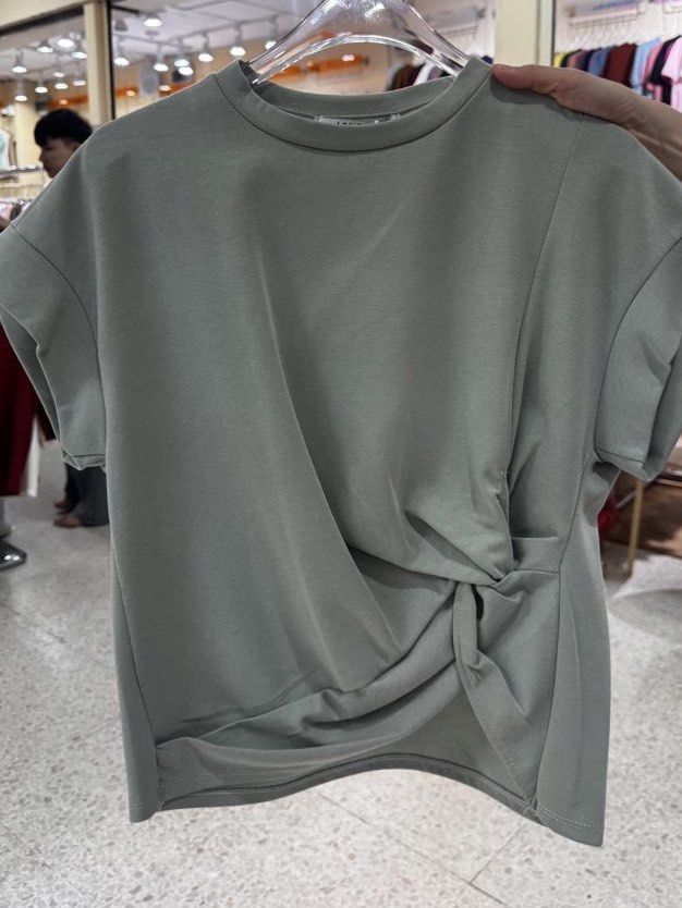 Mosaic Like Twisted Front Blouse from Bangkok (Multiple Colors Available) (Category: Blouses) located in Quezon City. Submitted by 0913cartz (Listing ID 1452370365, Image 3). Description: - Casual short-sleeve tee - Unique twisted knot detail on the front - Soft and comfortable fabric - Available colors: light blue, black, sage green, dark grey - Easy to pair with jeans or skirts - Ideal for everyday wear.