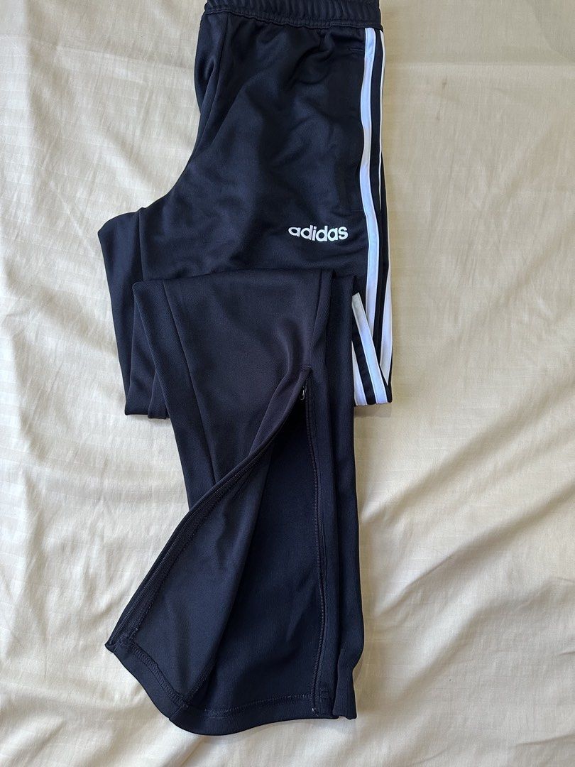 Adidas Black Track Pants with White Stripes (Category: Other Bottoms) located in Abulug. Submitted by coocus (Listing ID 1452390265, Image 3). Description: - Classic black Adidas track pants - Iconic white stripes down the sides - Zippers at the ankle for adjustable fit - Comfortable and versatile for sports or casual wear - Made in Cambodia.