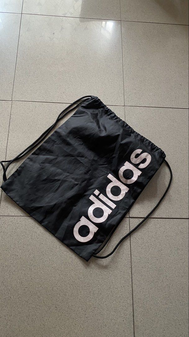 Adidas Drawstring Bag Black (Category: Backpacks) located in Cavite. Submitted by bocchi64 (Listing ID 1452349313, Image 1). Description: *NEED WASH* - Brand: Adidas - Type: Drawstring Bag - Origin: Made in Indonesia - Material: 100% Polyester - Max Weight Capacity: 2kg - Care Instructions: Clean with a moist cloth - Ideal for: Gym, everyday use, carrying essentials mop: gcash | maya mod: j&t | lalamove | meet up ( if near ) *buyer should pay for