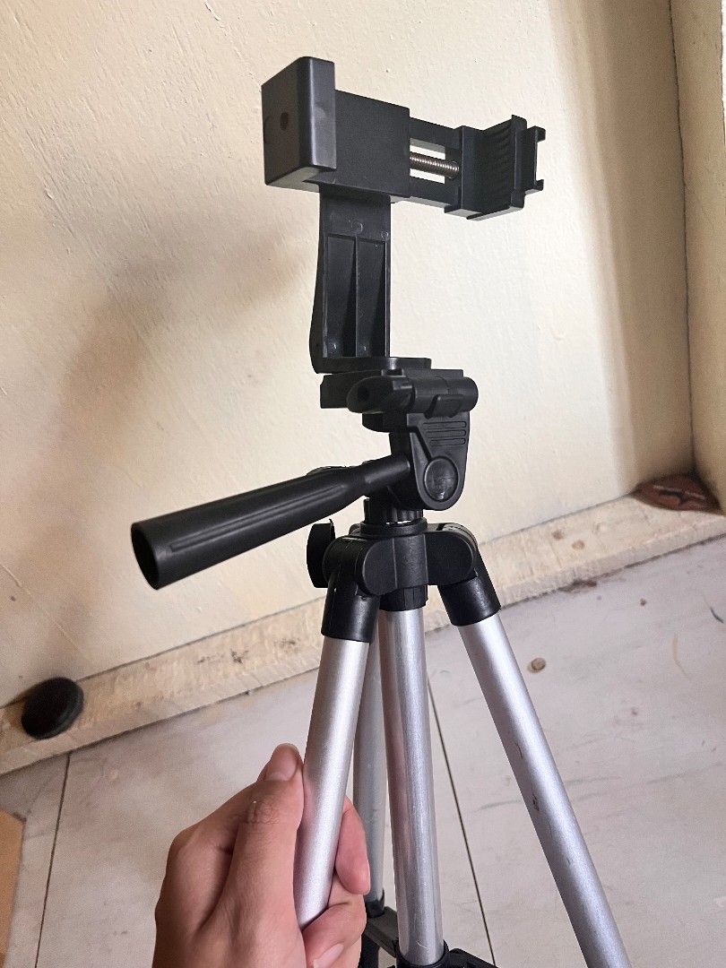 Adjustable Tripod with Phone Holder (Category: Tripods & Monopods) located in Bulacan. Submitted by decluttermeans (Listing ID 1452370665, Image 3). Description: Rfs: Decluttering LOC: San Jose Del Monte, Bulacan ΜΟΡ: Gcash/PayMava MOD: J&T (delivery fee is shouldered by the buyer) Can do meetup (Starmall & SM tungko) PM me for inquiries.