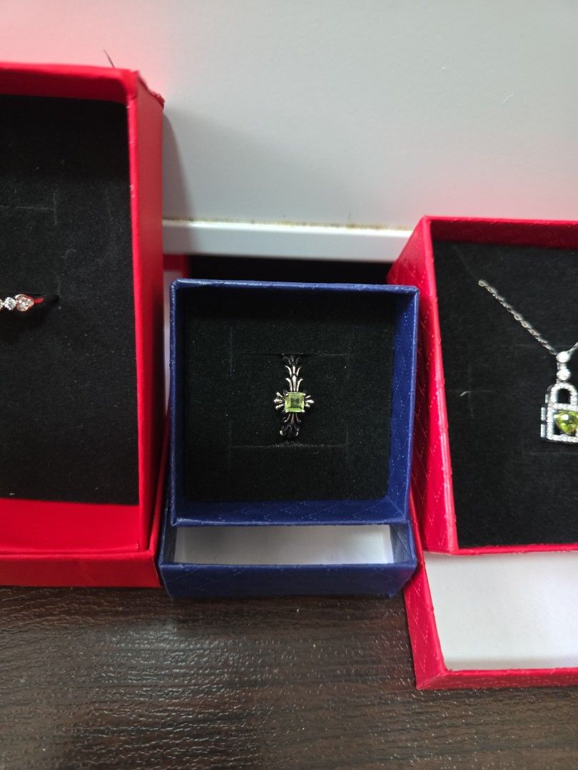 Assorted Ring (Category: Necklaces) located in Singapore. Submitted by draven23 (Listing ID 1452357487, Image 3). Description: - Beautiful Peridot and Diamond Ring & Necklace Set - Ring features a clover design with green stone and small diamonds - Necklace has a rectangular pendant with green stone and diamonds - Both pieces come in their original boxes - Ideal for gifting or personal indulgence - Not sure made of what, not for fussy who wants r