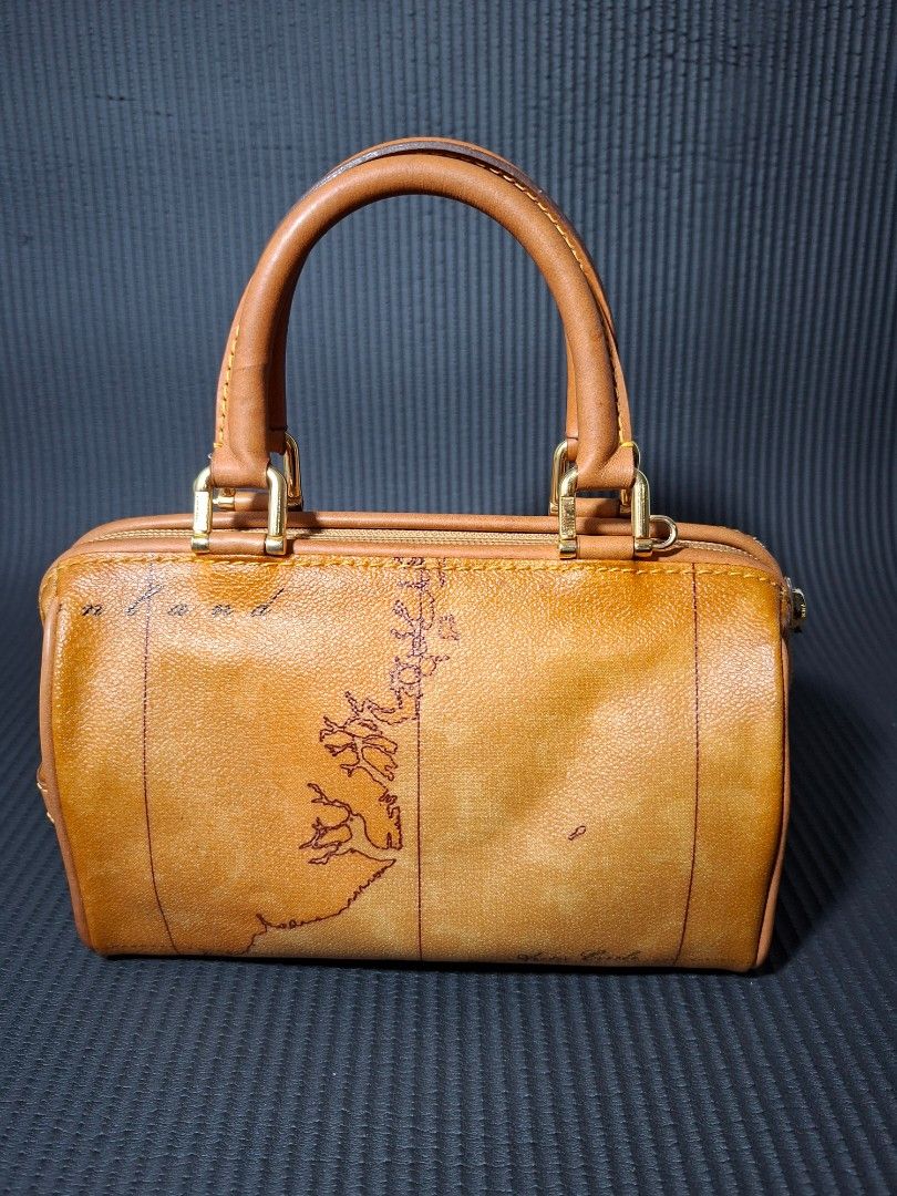 Authentic Alviero Martini Boston Bag Map Print (Category: Luxury Bags & Wallets) located in Quezon City. Submitted by happycloset25 (Listing ID 1452505496, Image 2). Description: - Authentic Alviero Martini mini Boston bag - Iconic map print featuring a rare, centered South America map - Clearly labeled: Uruguay, Argentina, Buenos Aires - Dimensions: 20 cm (bottom length) - Comes with a detachable strap.