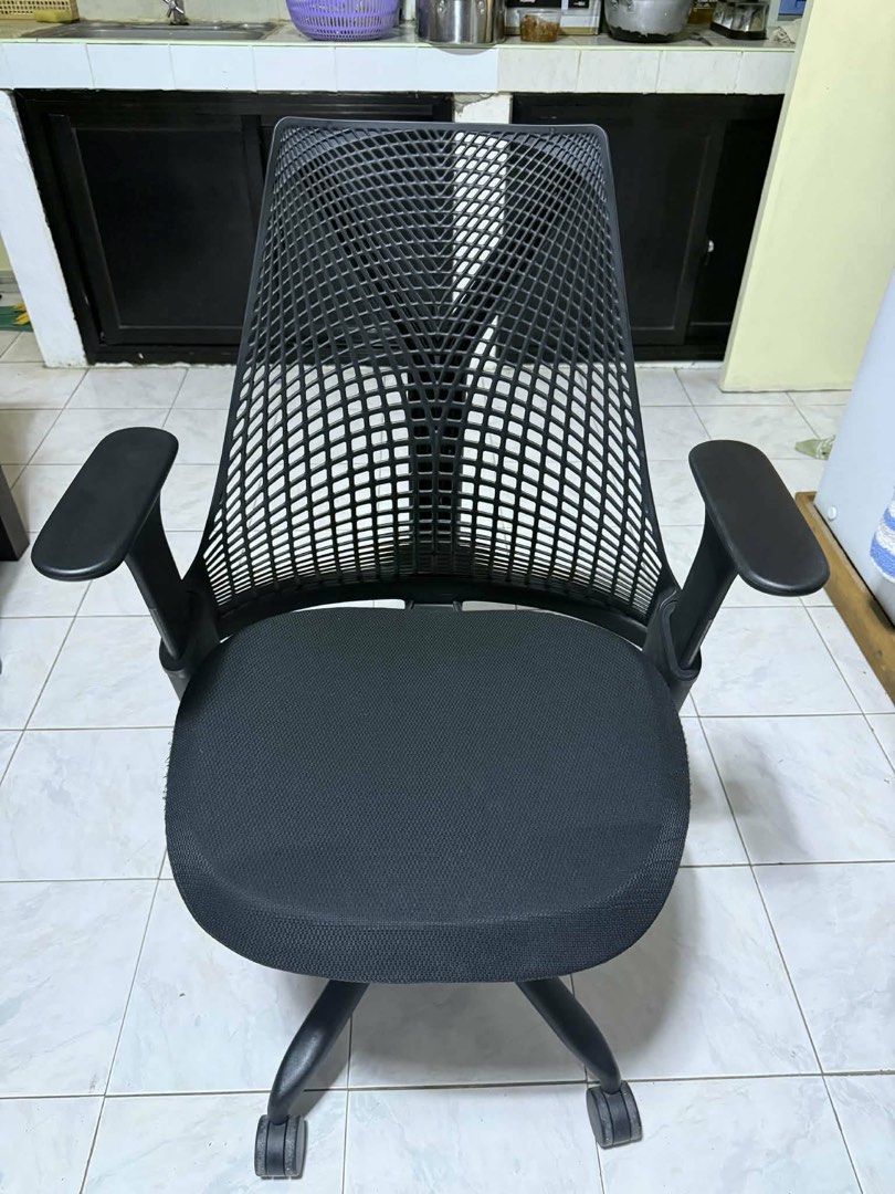 Authentic Herman Miller Sayl Chair (Category: Office Furniture & Fixtures) located in Manila. Submitted by jason_lt (Listing ID 1452342319, Image 2). Description: - *Fabric Seat*: Breathable and comfortable - *Ventilated Elastomer Backrest*: Provides targeted support and ventilation - *Adjustable Height and Armrests*: Allows for customized fit and comfort - *Synchronized Tilt and Lock*: Enables reclining and locking in place - *Additional Feature