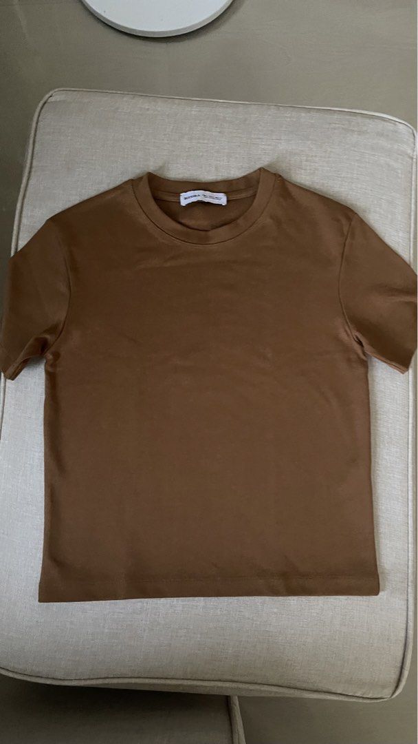 Bershka Mustard Brown Basic Crew Neck Shirt (Category: Shirts) located in Angat. Submitted by eltiff (Listing ID 1452433143, Image 2). Description: - Washed but never worn - Fits up to bust size 34 - Color: Mustard Brown - Style: Semi crop/ Boxy - Neckline: Crew neck - Sleeves: Short sleeves - Features: Soft fabric, versatile, easy to pair.