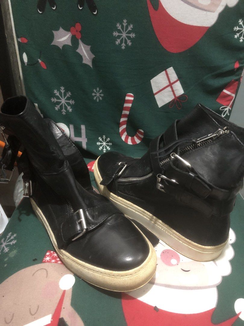 Black Leather Zip Up Buckle Boots (Category: Boots) located in Quezon City. Submitted by unique2shop (Listing ID 1452449181, Image 2). Description: - Black leather high-top boots - Zip and buckle details for an edgy look - Comfortable sneaker sole - Shows some scuffing on soles and leather - Ideal for everyday wear.