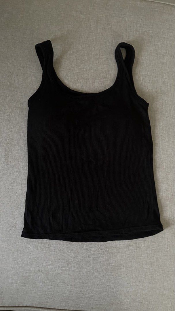 Black Ribbed Tank Top (Category: Sleeveless) located in Angat. Submitted by eltiff (Listing ID 1452429289, Image 2). Description: - Washed but never worn - Fits up to bust size 81-86 cm - Classic black ribbed tank top - Comfortable stretchy material - Flattering scoop neckline - Wide, supportive straps - Ideal for layering or standalone wear - Effortlessly versatile for any outfit.
