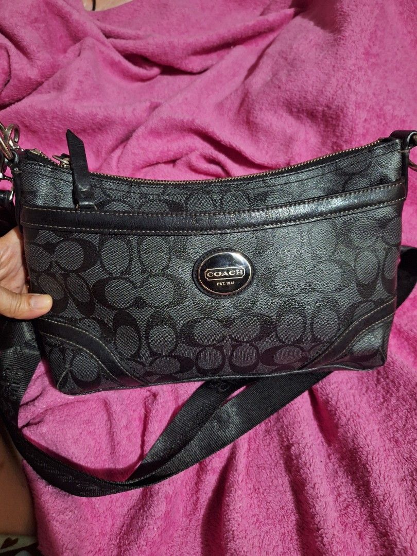 Coach Monogram Canvas Shoulder Bag (Category: Luxury Bags & Wallets) located in Quezon City. Submitted by cloudymay (Listing ID 1452331489, Image 2). Description: - Coach shoulder bag - Classic black monogram pattern - Secure zip top closure - Interior leather tag with serial number - Stylish silver hardware details - Adjustable strap for comfort - Ideal for everyday wear - replaced sling, can be a kili bag if you have a short strap available. -K
