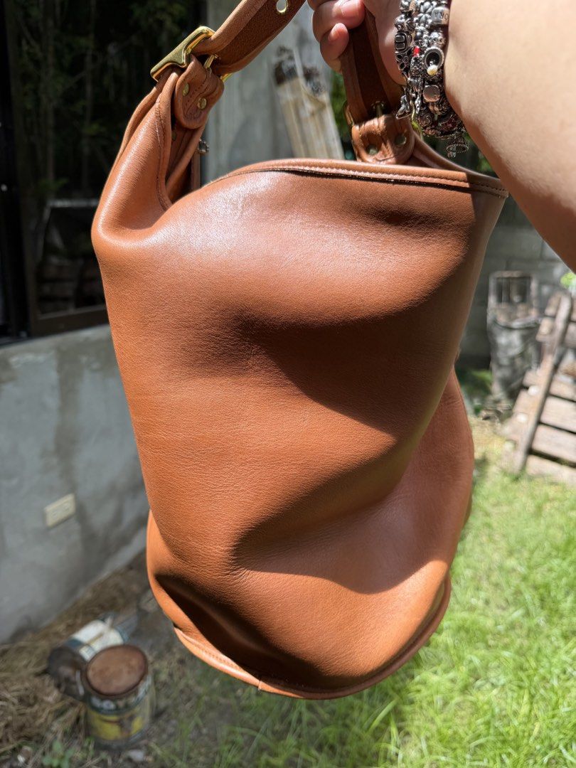 COACH VINTAGE DUFFLE SAC 9085 (Category: Luxury Bags & Wallets) located in General Santos City (Dadiangas). Submitted by prelovedpickers (Listing ID 1452363650, Image 2). Description: Vintage large hobo shoulder bag from Coach-- A roomy bucket style bag, this purse features round bottom construction, butterfly soft leather , adjustable strap with brass hardware, and interior slip pocket. British tan leather exterior in Excellent condition Origina