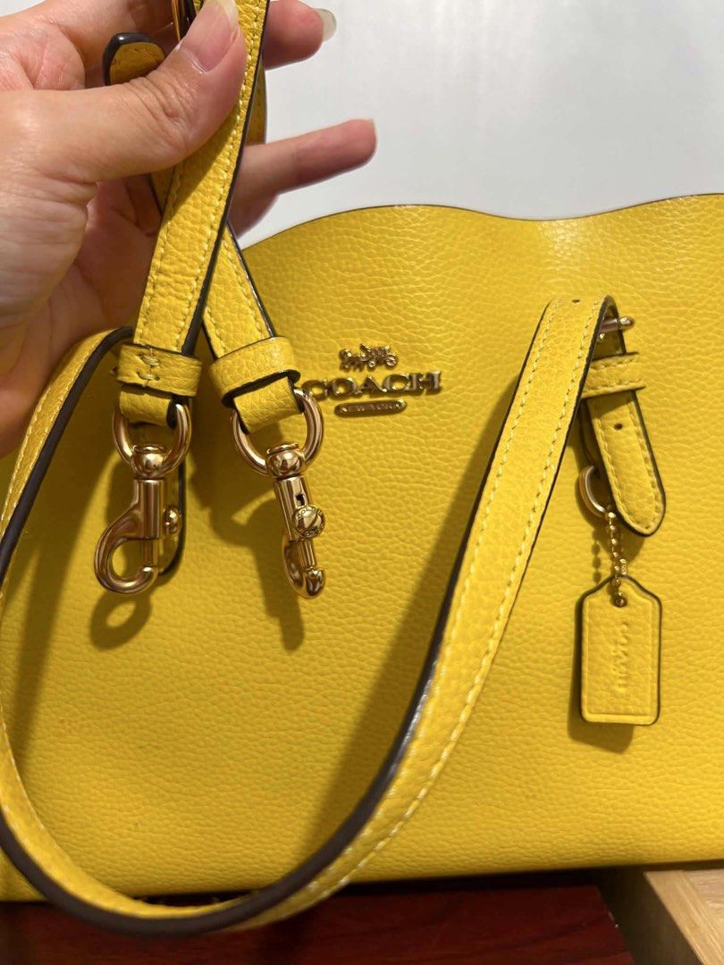 Coach Yellow Pebbled Leather Tote Bag (Category: Luxury Bags & Wallets) located in Iriga City. Submitted by pureloveyaes (Listing ID 1452323199, Image 2). Description: - Coach yellow pebbled leather tote - Gold hardware details - Coach hangtag included - Pink interior - Comes with care instructions - Ideal for everyday use.