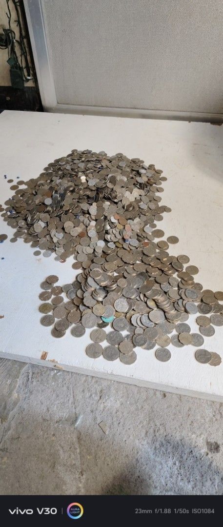 Collection of Assorted foreign Coins (Category: Currency) located in Manila. Submitted by roblazo25 (Listing ID 1452321086, Image 1). Description: - Large pile of assorted coins - Mix of different denominations and possibly currencies - Perfect for coin collectors or sorting enthusiasts - Comes with a bucket and a blue bag - Plenty of coins included! -450 per kilo.