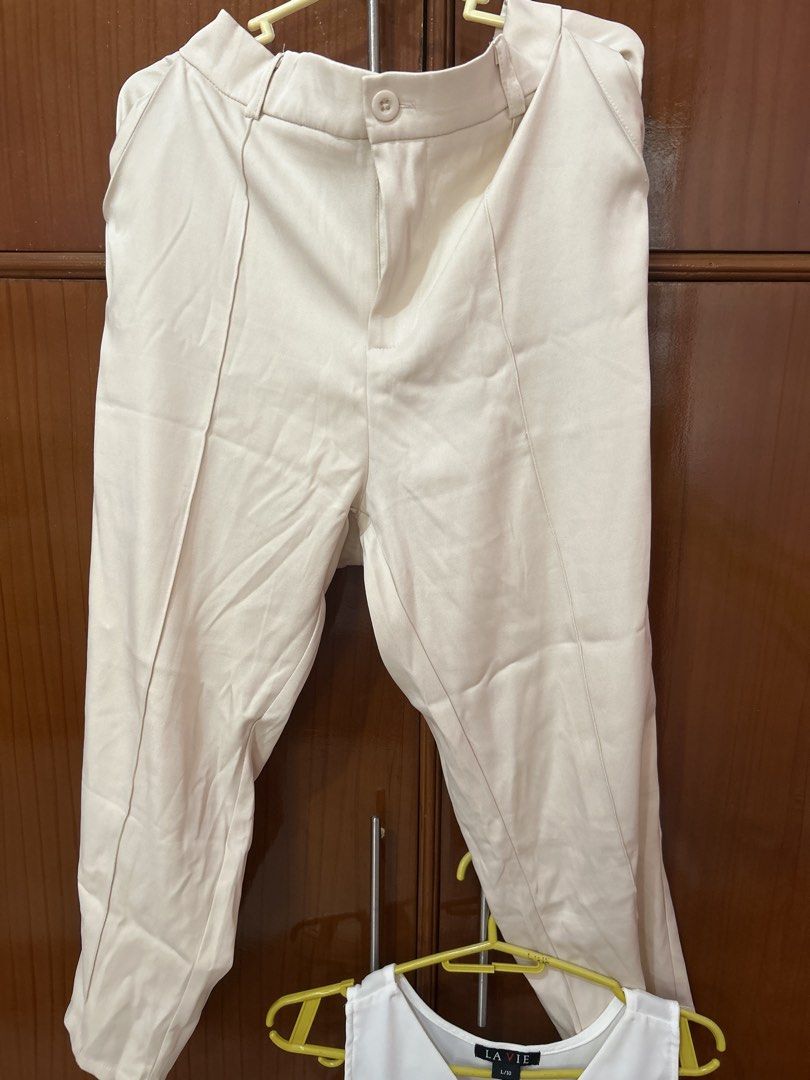 Cream Trousers and White V-Neck Top Set (Category: Sets or Coordinates) located in Cauayan City . Submitted by lenkapreloved (Listing ID 1452346196, Image 3). Description: - Cream colored trousers with button and zip closure - Straight leg cut - Simple white sleeveless V-neck top - Both pieces are versatile and can be worn together or separately - Suitable for casual or semi-formal occasions - Easy to mix and match with other wardrobe staples.