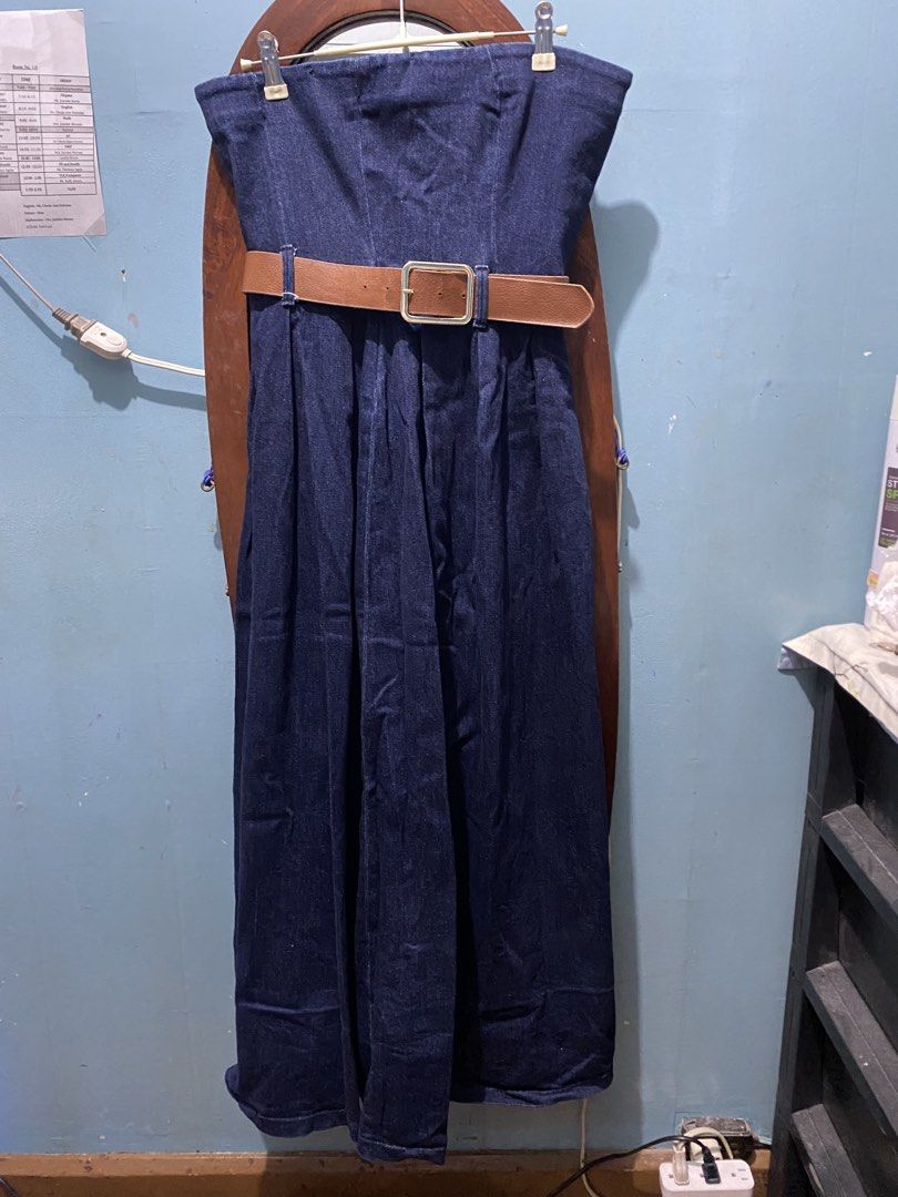 Denim Strapless Jumpsuit with Belt (Category: Dresses) located in Manila. Submitted by mimi_goods.ph (Listing ID 1452423894, Image 1). Description: - Dark wash denim strapless jumpsuit - Wide leg design with pleats - Comes with a brown faux leather belt with a gold buckle - Versatile for casual or night out looks - Easy to style up or down.
