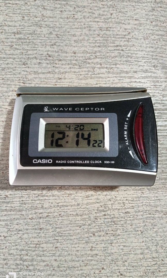 Digital casio (Category: Clocks) located in Quezon City. Submitted by Bernz (Listing ID 1452366556, Image 1). Description: The selected item is a Casio Wave Ceptor DQD-100 digital radio-controlled table clock featuring a silver-and-black casing, a clear LCD screen displaying the time and date, and an alarm setting slider on the side. [1, 2, 3] Key Specifications & Features Model: Casio Wave Ceptor DQD-100 (or DQD-100X variant) Core Functions: Rad
