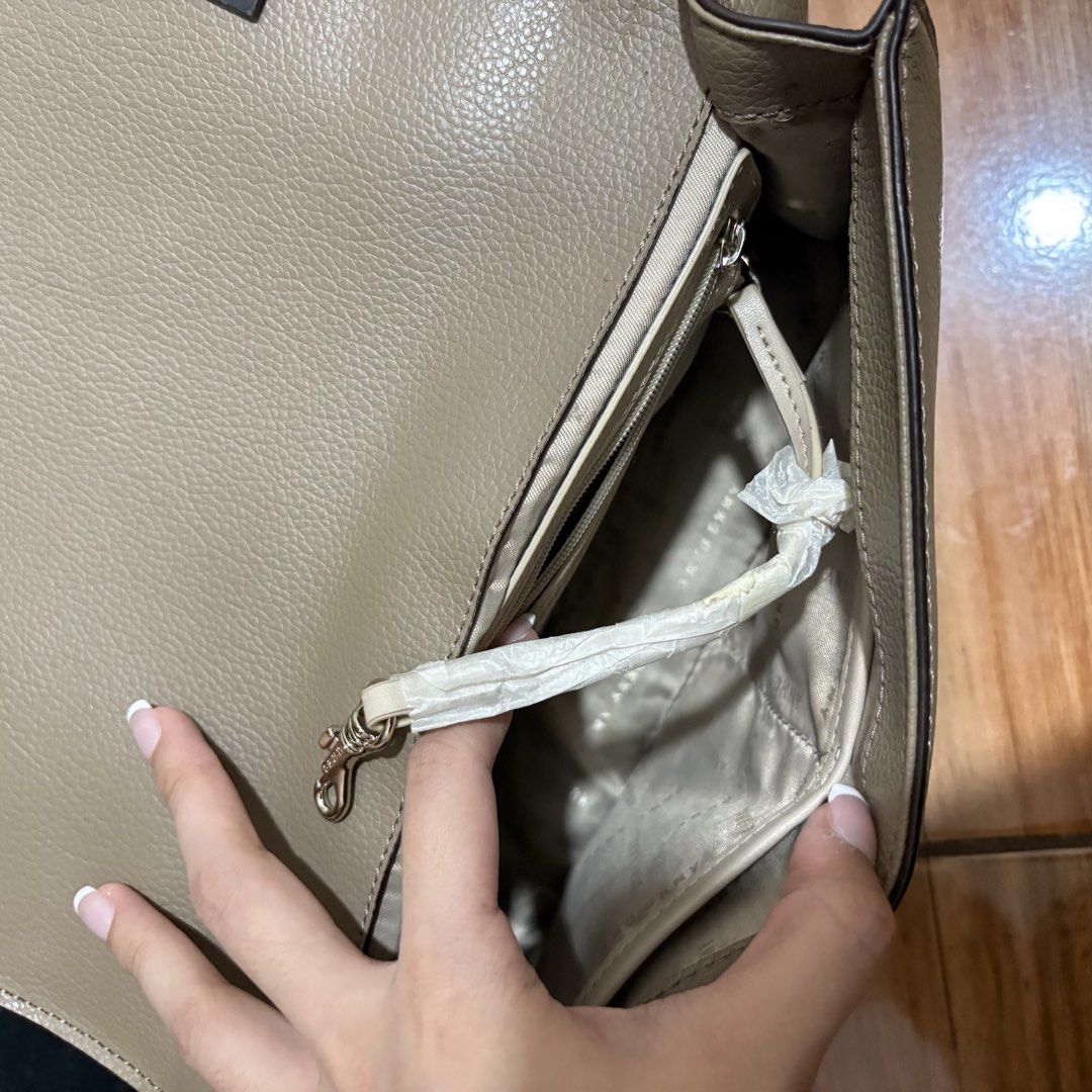 DKNY Leather Shoulder Bag with Chain Strap and Lock Charm (Category: Shoulder Bags) located in Subic. Submitted by ysbllrs (Listing ID 1452437341, Image 3). Description: - Authentic DKNY shoulder bag DKNY ELISSA LOGO BAG - Color: Taupe - Material: Genuine Leather - Features: Gold chain strap, decorative lock charm - Interior: Multiple compartments, zippered pocket - Includes: Original dust bag and tags - Note: Natural leather variations.