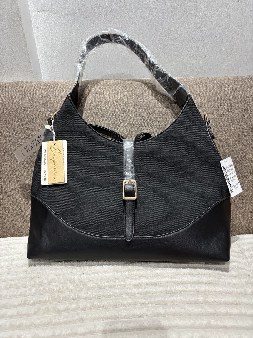Emperia Black Shoulder Bag - Vegan Leather (Category: Shoulder Bags) located in Mexico. Submitted by 3everything (Listing ID 1452420934, Image 1). Description: - Brand: Emperia - Color: Black - Material: Vegan Leather - Features: Buckle detail on front, detachable strap - Condition: Brand new with original tags attached - Original Retail Price: $899.00 - Outlet Price: $699.00.