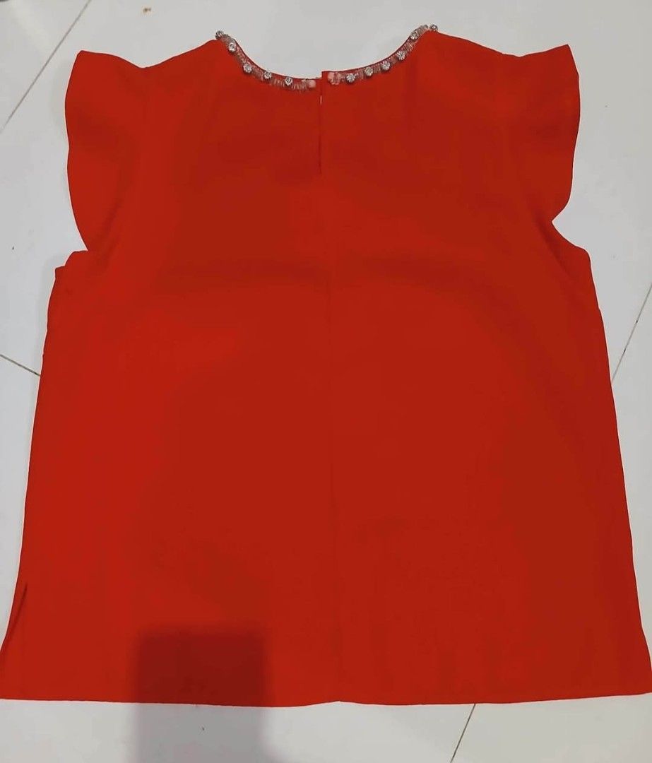 Forever 21 Red Embellished Neckline Top Size M (Category: Sleeveless) located in Taguig. Submitted by cutifyjean (Listing ID 1452433935, Image 2). Description: - Brand: Forever 21 - Color: Red - Size: Medium (M) - Neckline: Beaded and jeweled for a touch of sparkle - Sleeves: Short flutter sleeves - Closure: Button at the back neck - Style: Perfect for dressing up or down, very versatile - Good as new twice used.