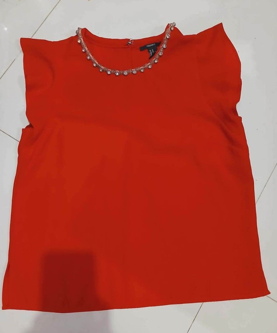 Forever 21 Red Embellished Neckline Top Size M (Category: Sleeveless) located in Taguig. Submitted by cutifyjean (Listing ID 1452433935, Image 3). Description: - Brand: Forever 21 - Color: Red - Size: Medium (M) - Neckline: Beaded and jeweled for a touch of sparkle - Sleeves: Short flutter sleeves - Closure: Button at the back neck - Style: Perfect for dressing up or down, very versatile - Good as new twice used.
