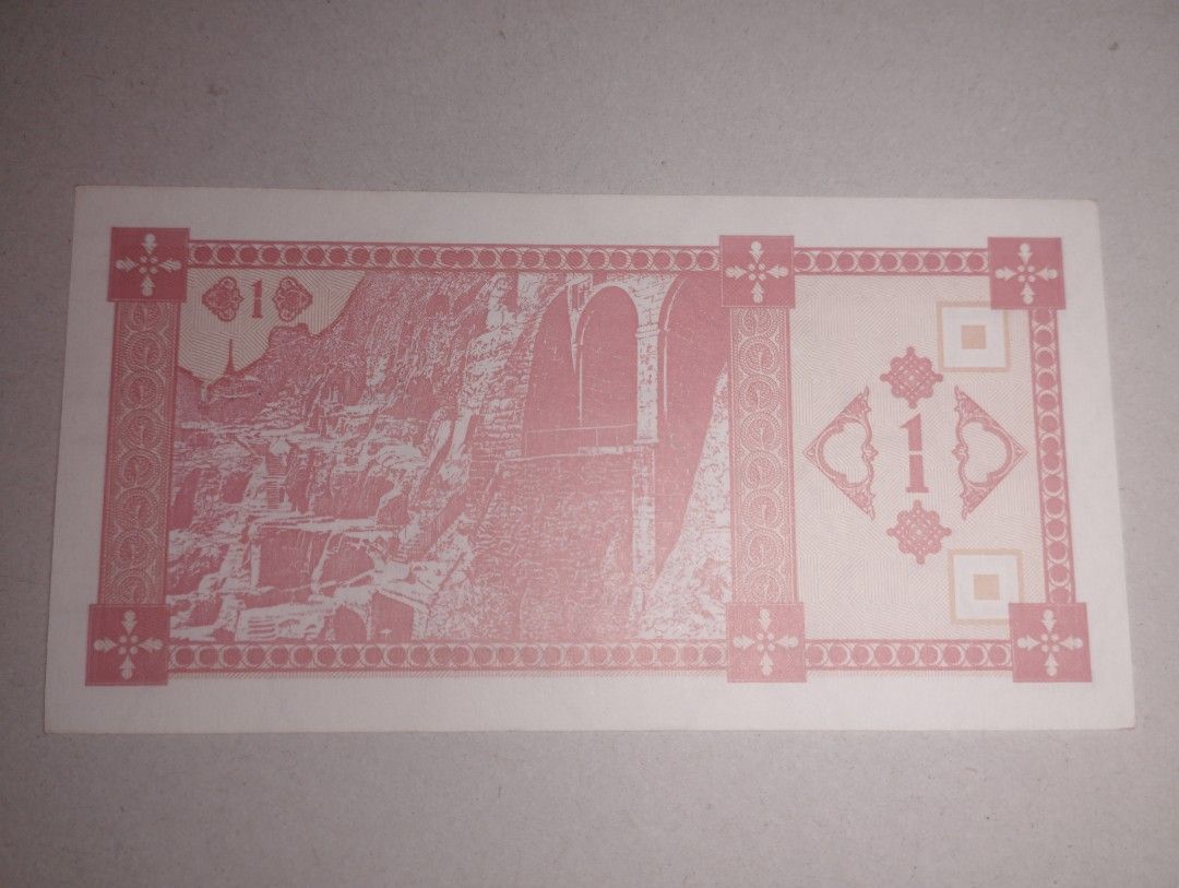 Georgia - 1 Kuponi(1993) (Category: Currency) located in Baguio. Submitted by maximum_carnage (Listing ID 1452454654, Image 2). Description: - Genuine 1 Kuponi banknote from Georgia. - Eye-catching pink design with intricate patterns. - Features a mountain landscape with buildings and a horseman on one side. - Reverse side displays a prominent '1' symbol and architectural details. - Ideal for banknote collectors or as a unique souvenir from Georg