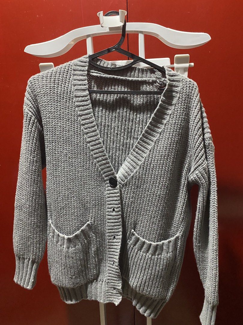 Grey Knit Cardigan with Pockets (Category: Coats, Jackets and Outerwear) located in Bauang. Submitted by nrrandomthings (Listing ID 1452472648, Image 2). Description: - Grey knit cardigan - Open front style - Two front pockets - Ribbed cuffs and hem - Button-up option available (see second photo) - Comfortable and versatile for layering - Ideal for cooler weather.