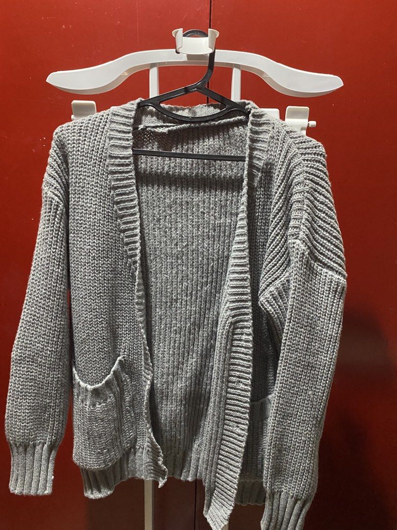 Grey Knit Cardigan with Pockets (Category: Coats, Jackets and Outerwear) located in Bauang. Submitted by nrrandomthings (Listing ID 1452472648, Image 1). Description: - Grey knit cardigan - Open front style - Two front pockets - Ribbed cuffs and hem - Button-up option available (see second photo) - Comfortable and versatile for layering - Ideal for cooler weather.