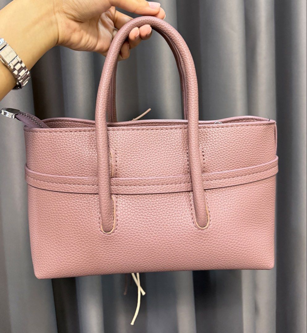 Hand/Crossbody Bag with Charm (Category: Cross-body Bags) located in Manila. Submitted by withluvbee (Listing ID 1452331195, Image 2). Description: - With free charm and crossbody strap - Adorable pink textured handbag - Convenient top handles for carrying - Spacious interior for your essentials - Versatile for everyday use or a night out.