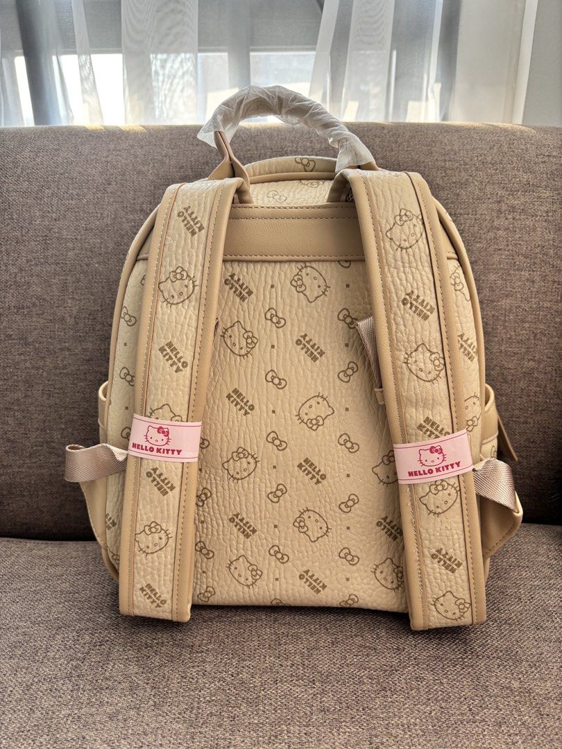 Hello Kitty Beige Monogram Backpack (Category: Backpacks) located in Mexico. Submitted by 3everything (Listing ID 1452421176, Image 2). Description: - Adorable beige backpack featuring an all-over Kitty and bow print. - Convenient front zip pocket for easy access to essentials. - Adjustable straps for a comfortable, customized fit. - Comes with a complimentary Kitty dust bag and box - Ideal for everyday adventures or your next getaway..