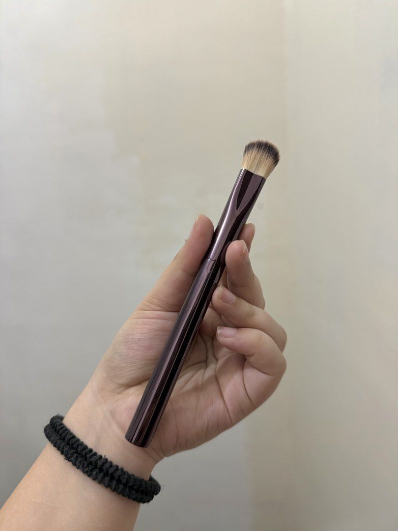 Hourglass Makeup Brush (Category: Makeup) located in Cebu City. Submitted by pinkflames05 (Listing ID 1452390807, Image 2). Description: - Hourglass makeup brush - Deep plum handle with subtle striping - Dense, tapered brush head for foundation or concealer - Small mark on handle (visible in last photo) - Cleaned and sanitized, ready for a new home - Issue: may little crack as u can see sa last photo.