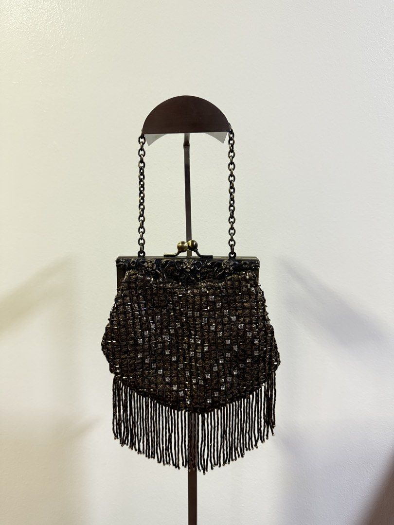Jessica McClintock Brass Frame Evening Bag with Chain (Category: Clutches) located in Carmona. Submitted by prelovedbyallia (Listing ID 1452473992, Image 1). Description: Vintage Jessica McClintock clutch • Elegant brass frame with beaded fringe detail •Black satin interior with a convenient small pocket •Includes a detachable brass chain strap for versatility •Approximate measurements: 6 inches wide, 5 inches tall • Condition: clean interior!! O