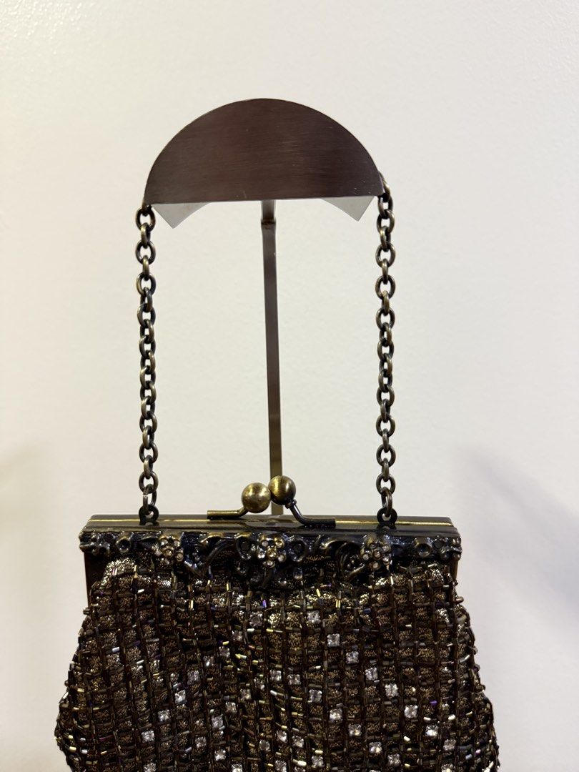 Jessica McClintock Brass Frame Evening Bag with Chain (Category: Clutches) located in Carmona. Submitted by prelovedbyallia (Listing ID 1452473992, Image 2). Description: Vintage Jessica McClintock clutch • Elegant brass frame with beaded fringe detail •Black satin interior with a convenient small pocket •Includes a detachable brass chain strap for versatility •Approximate measurements: 6 inches wide, 5 inches tall • Condition: clean interior!! O
