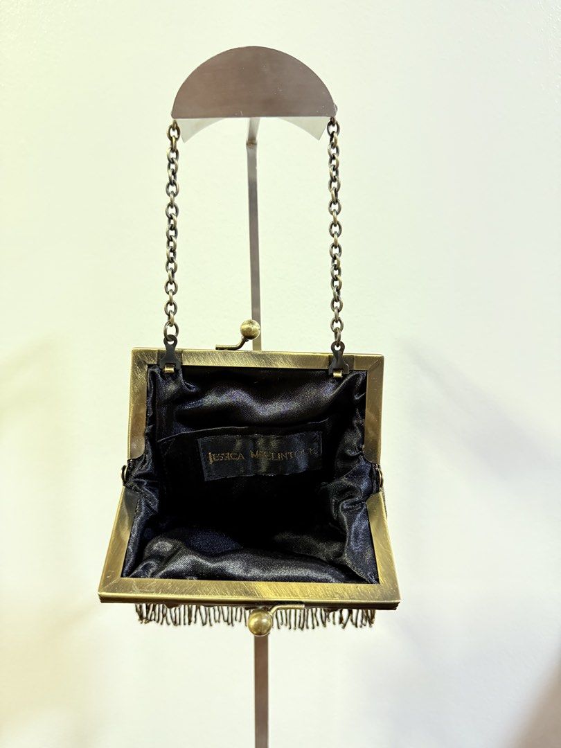 Jessica McClintock Brass Frame Evening Bag with Chain (Category: Clutches) located in Carmona. Submitted by prelovedbyallia (Listing ID 1452473992, Image 3). Description: Vintage Jessica McClintock clutch • Elegant brass frame with beaded fringe detail •Black satin interior with a convenient small pocket •Includes a detachable brass chain strap for versatility •Approximate measurements: 6 inches wide, 5 inches tall • Condition: clean interior!! O