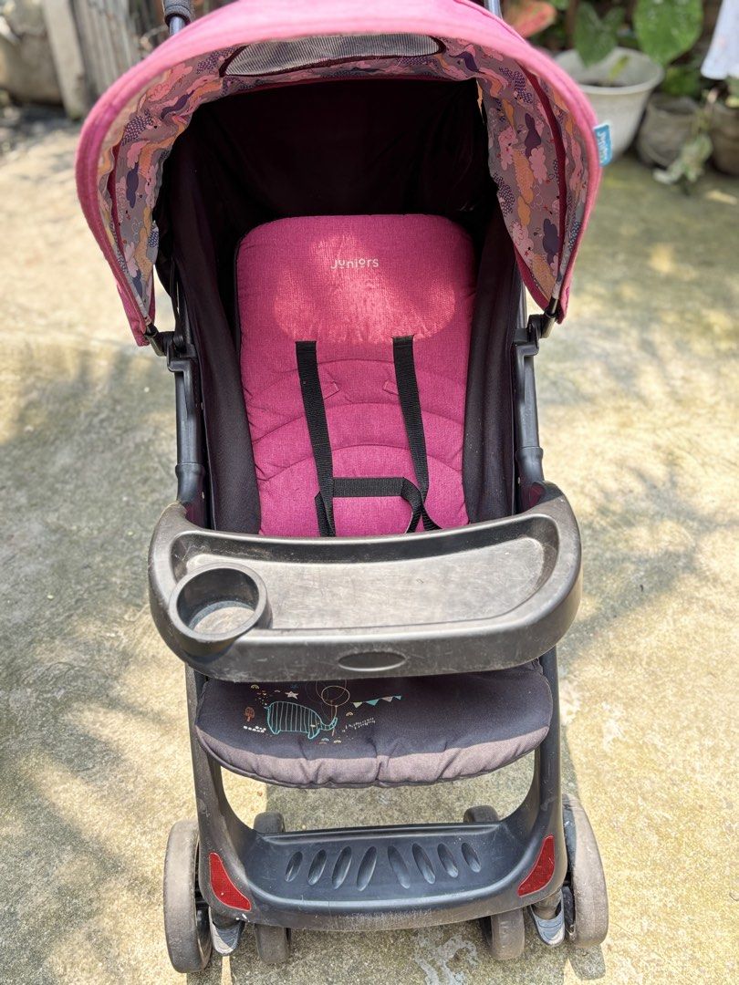 Juniors Baby Stroller - Pink (Category: Strollers) located in Malabon City. Submitted by kwisteyndg (Listing ID 1452374006, Image 2). Description: - Pink junior stroller - Canopy with floral print - Tray with cup holder - Storage basket underneath - Safety harness - Folds for easy storage - Ready for your little one's adventures!.