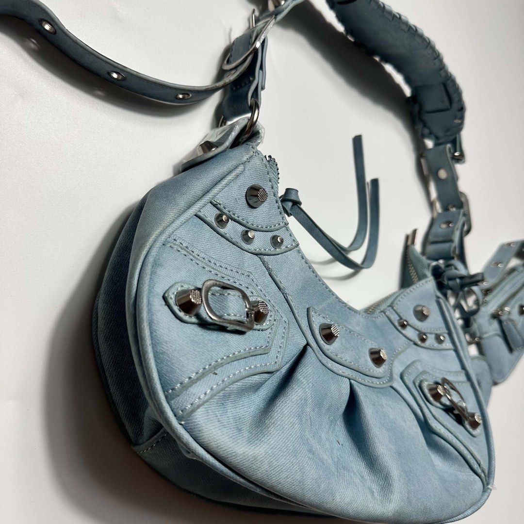 Light Blue Denim Shoulder Bag with Pouch and Mirror Charm (Category: Shoulder Bags) located in San Fernando. Submitted by cozzzer (Listing ID 1452340685, Image 3). Description: - Cute light blue denim shoulder bag - All-over silver stud details - Comes with a matching small pouch - Includes a heart-shaped mirror charm - Adjustable strap - Great for everyday use Balenciaga Inspired Bag No issue Brand new condition Price-900 add shipping fee.