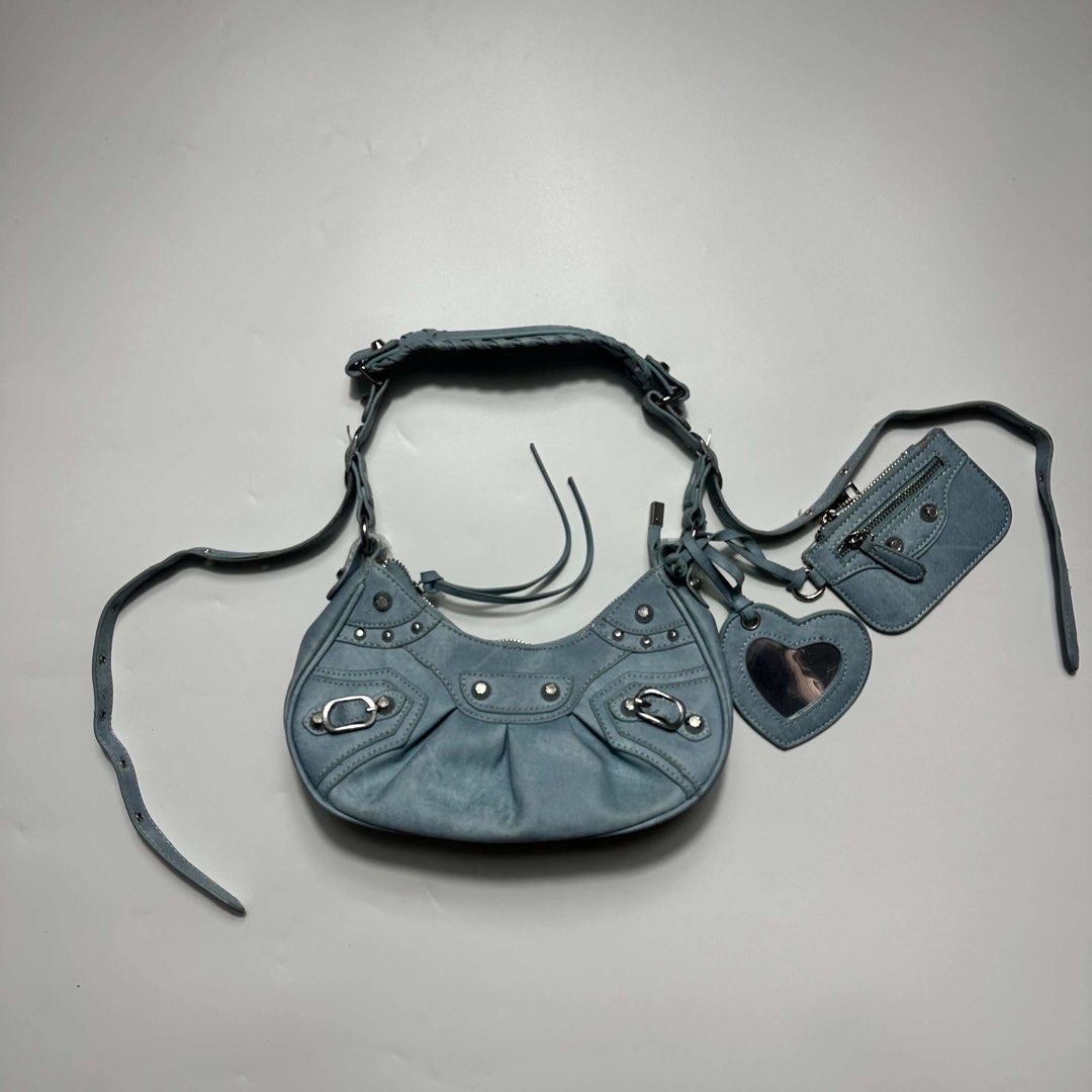 Light Blue Denim Shoulder Bag with Pouch and Mirror Charm (Category: Shoulder Bags) located in San Fernando. Submitted by cozzzer (Listing ID 1452340685, Image 1). Description: - Cute light blue denim shoulder bag - All-over silver stud details - Comes with a matching small pouch - Includes a heart-shaped mirror charm - Adjustable strap - Great for everyday use Balenciaga Inspired Bag No issue Brand new condition Price-900 add shipping fee.