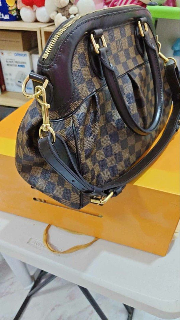 Louis Vuitton Damier Ebene Trevi PM (Category: Luxury Bags & Wallets) located in Manila. Submitted by yuanres5 (Listing ID 1452425662, Image 3). Description: - Authentic Louis Vuitton trevi PM - Damier Ebene canvas - Rolled leather handles - Detachable shoulder strap - Gold hardware - Interior zip pocket - Comes with dust bag and box - Perfect everyday bag - hardware very good condition No returns.
