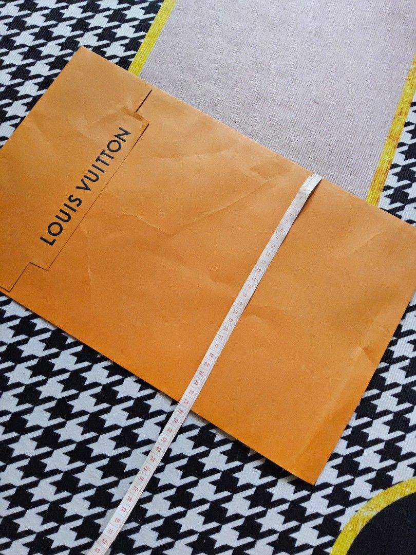 Louis Vuitton Orange Paper Bag (Category: Luxury Bags & Wallets) located in Alaminos. Submitted by shee09 (Listing ID 1452361014, Image 3). Description: - Authentic Louis Vuitton paper bag - Vibrant orange color - Approximately 48cm in length - Perfect for storing small items or as a stylish gift bag.