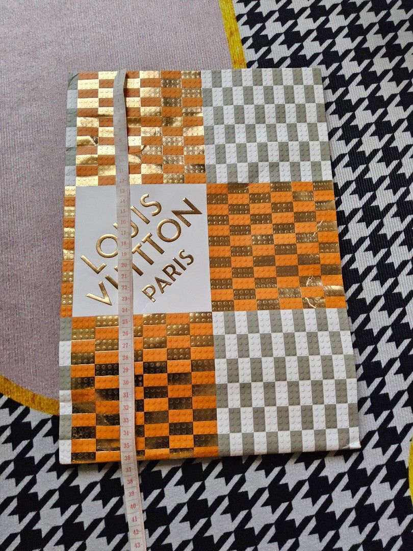 Louis Vuitton Paris Paper Bag (Category: Luxury Bags & Wallets) located in Alaminos. Submitted by shee09 (Listing ID 1452364942, Image 3). Description: - Authentic Louis Vuitton Paris Paper bag - Unique checkered and orange pattern - Grey ribbon handles - Ideal for gifting or storage - Approximate dimensions: 30cm x 25cm x 10cm.