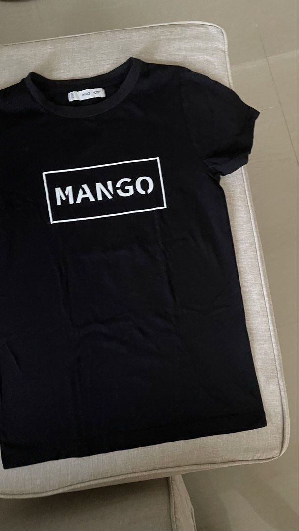 Mango Black T-shirt with White Logo (Category: Shirts) located in Angat. Submitted by eltiff (Listing ID 1452438124, Image 3). Description: - Worn once only - Fits up to bust size 34 - Color: Black - Design: Classic t-shirt with white Mango logo on front - Material: Comfortable cotton - Style: Casual, easy to pair with jeans or shorts.