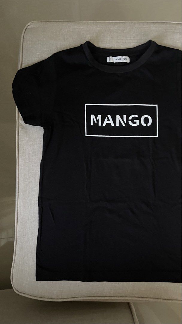 Mango Black T-shirt with White Logo (Category: Shirts) located in Angat. Submitted by eltiff (Listing ID 1452438124, Image 2). Description: - Worn once only - Fits up to bust size 34 - Color: Black - Design: Classic t-shirt with white Mango logo on front - Material: Comfortable cotton - Style: Casual, easy to pair with jeans or shorts.