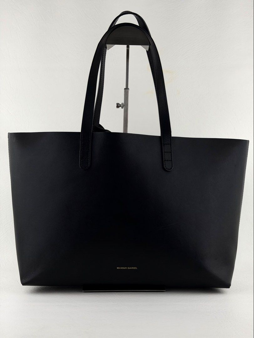 MANSUR GAVRIEL Icon Tote (Category: Luxury Bags & Wallets) located in Manila. Submitted by luvluxe.mnl (Listing ID 1452360615, Image 1). Description: Medium size— fits a lot Super nice & elegant!! With minimal signs of use inside seen in pic but the still presentable and well functional. Missing pouch Overall in very good condition Must have!!.