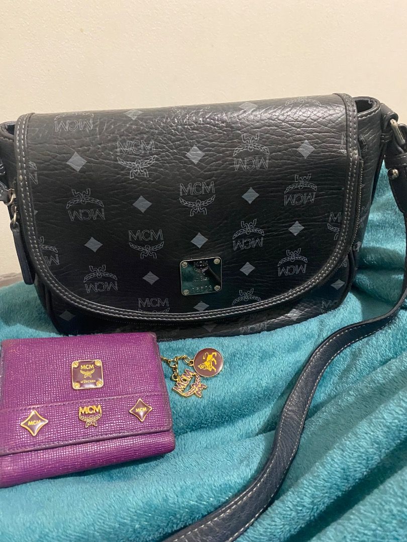 MCM Monogram Handbag and Purple Wallet Set (Category: Luxury Bags & Wallets) located in Paranaque City. Submitted by margauxjc39954 (Listing ID 1452475302, Image 1). Description: - MCM black monogram shoulder bag. - Matching purple MCM tri-fold wallet included. - Cute MCM charm attached to the wallet. - Ideal set for any MCM enthusiast. - SF shouldered by the buyer..