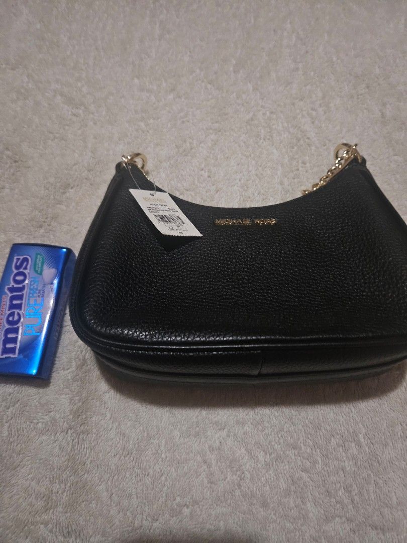 Michael Kors Black Leather Chain Shoulder Bag (Category: Luxury Bags & Wallets) located in Makati City. Submitted by diannecheryl (Listing ID 1452407880, Image 1). Description: - Brand: Michael Kors - Material: Black pebbled leather - Strap: Gold chain - Condition: New with original tags attached - Size: Small, ideal for essentials - Versatile: Perfect for nights out or everyday use.