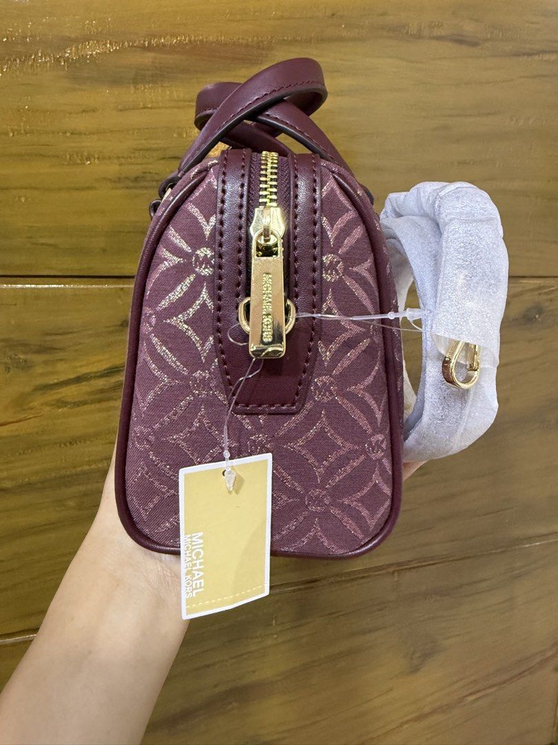 Michael Kors Travel Duffle Bag (Category: Luxury Bags & Wallets) located in Iriga City. Submitted by pureloveyaes (Listing ID 1452322608, Image 3). Description: - Brand: Michael Kors - Color: Burgundy with MK logo pattern - Hardware: Gold-tone - Features: Detachable shoulder strap - Condition: Brand new with original tags attached - Perfect for: Weekend trips.