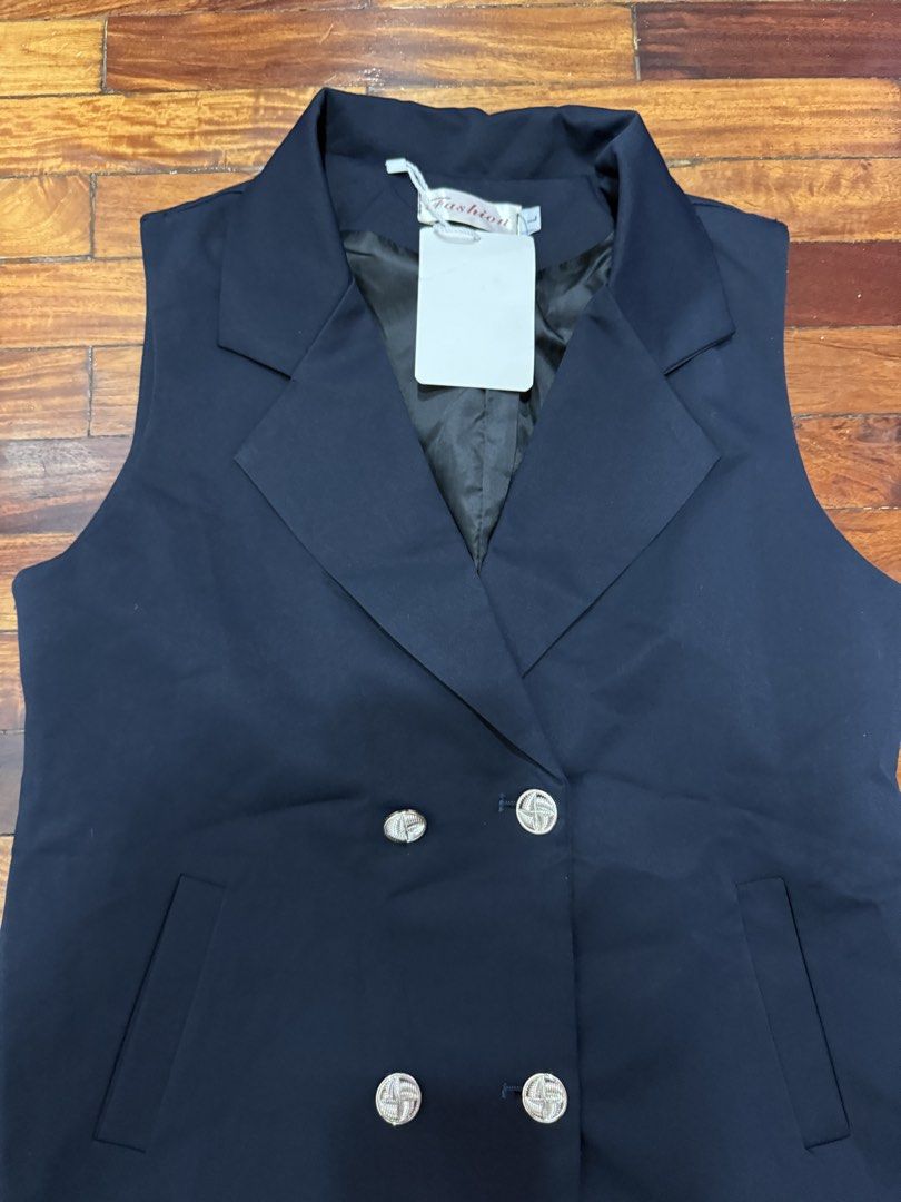 Navy Blue Sleeveless Blazer and Shorts Set (Category: Sets or Coordinates) located in Pasig City. Submitted by atbp__ (Listing ID 1452455893, Image 2). Description: - Navy blue sleeveless blazer and matching shorts set - Blazer: Double-breasted with silver-toned buttons - Shorts: Single button closure at waist - Both pieces are unhemmed - Ideal for a smart casual outfit.