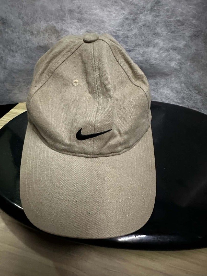 Nike Baseball Cap Tan Adjustable Strap (Category: Caps & Hats) located in Quezon City. Submitted by amber___18 (Listing ID 1452421702, Image 3). Description: - Classic tan Nike baseball cap - Iconic Nike swoosh embroidered on front and back - Adjustable strap for a comfortable, custom fit - Versatile for everyday wear or sports activities.