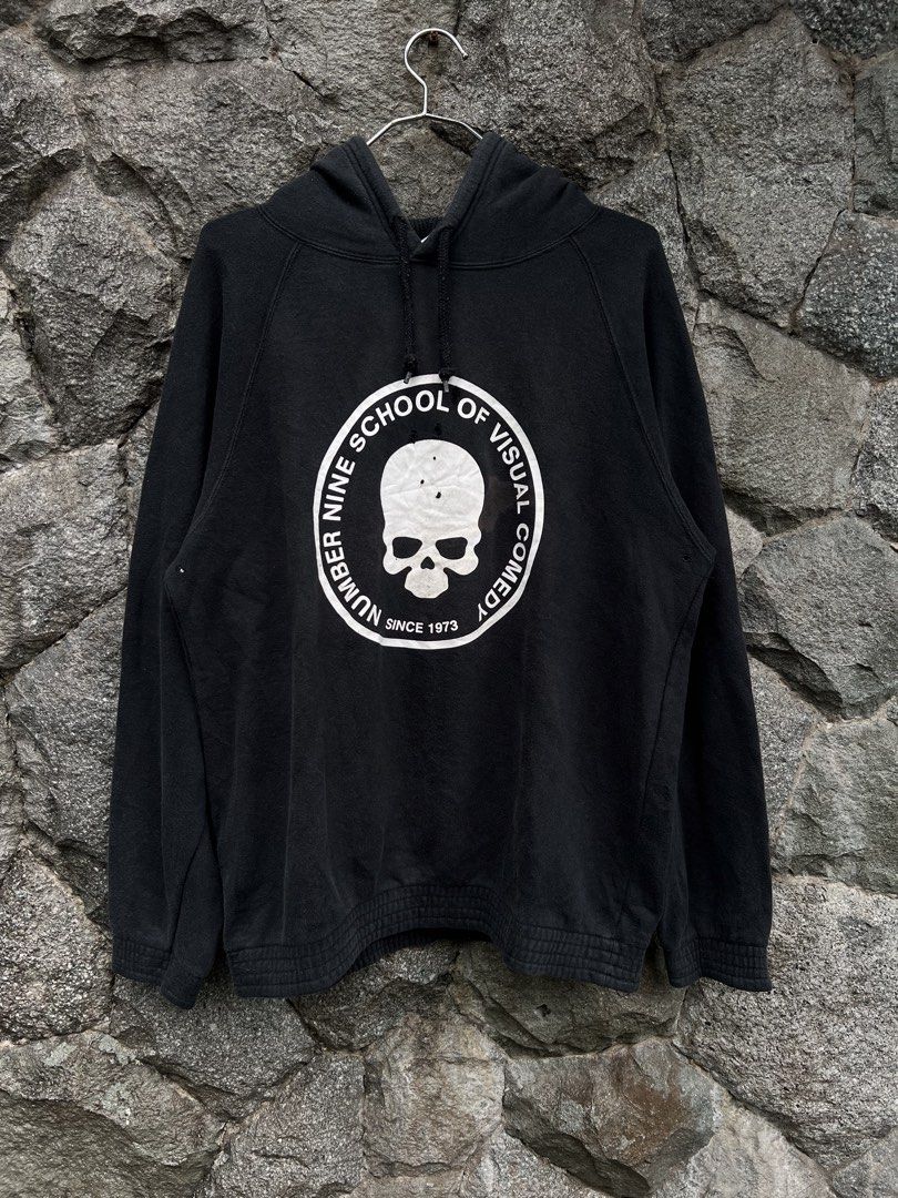 Number (N)ine School Of Visual Comedy (Category: Hoodies) located in Baguio. Submitted by pinkpixie (Listing ID 1452489834, Image 1). Description: - Brand: NUMBER NINE - Color: Black - Design: 'SCHOOL OF VISUAL COMEDY' graphic with skull and 'SINCE 1973' text on front - Condition: Minor holes and marks visible on front and back graphics - Features: Hood with drawstrings, ribbed cuffs, ribbed hem.