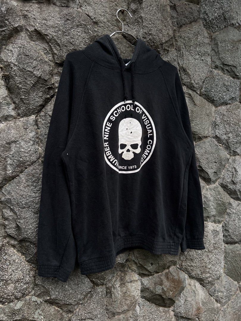Number (N)ine School Of Visual Comedy (Category: Hoodies) located in Baguio. Submitted by pinkpixie (Listing ID 1452489834, Image 3). Description: - Brand: NUMBER NINE - Color: Black - Design: 'SCHOOL OF VISUAL COMEDY' graphic with skull and 'SINCE 1973' text on front - Condition: Minor holes and marks visible on front and back graphics - Features: Hood with drawstrings, ribbed cuffs, ribbed hem.