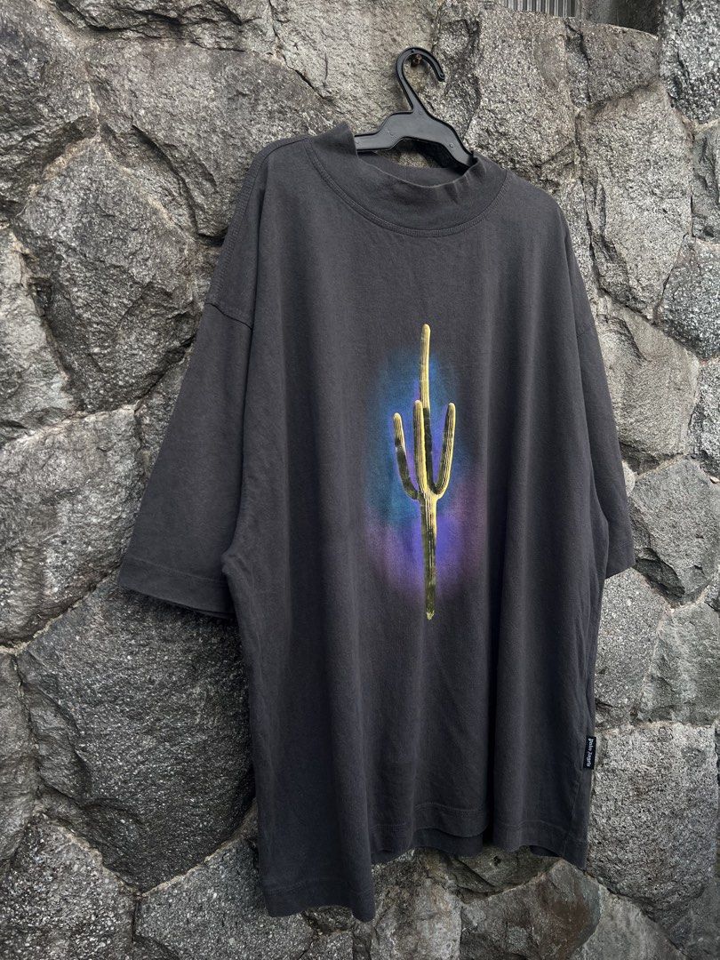 Palm Angels Cactus Graphic T-Shirt (Category: Tshirts & Polo Shirts ) located in Baguio. Submitted by pinkpixie (Listing ID 1452490254, Image 3). Description: Authentic - Dark grey t-shirt - Vibrant cactus graphic with purple & blue aura - Mock neck design - Short sleeves - Palm Angels side tag - Perfect statement piece.