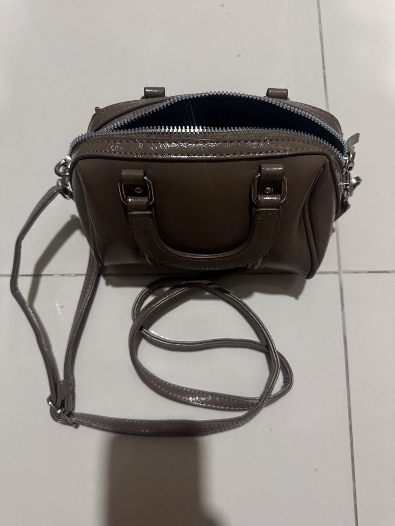 Parisian Brown Mini Boston Bag with Shoulder Strap (Category: Shoulder Bags) located in Manila. Submitted by lilag (Listing ID 1452463305, Image 1). Description: - Cute mini Boston bag in brown. - Features a top handle and a detachable shoulder strap. - Secure zipper closure. - Ideal for carrying your daily essentials. - No visible rusting or wear on the hardware but there’s a hole in the lining which could be fixed with simple mending RFS: Declu